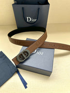 Brown leather belt with oval monogram buckle and embossed logo