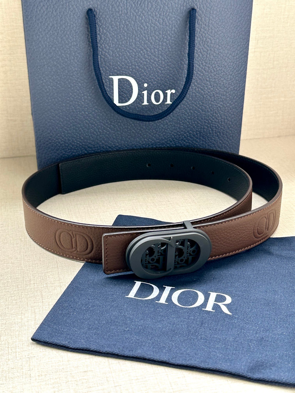 Brown leather Dior belt with oval buckle and embossed logo details