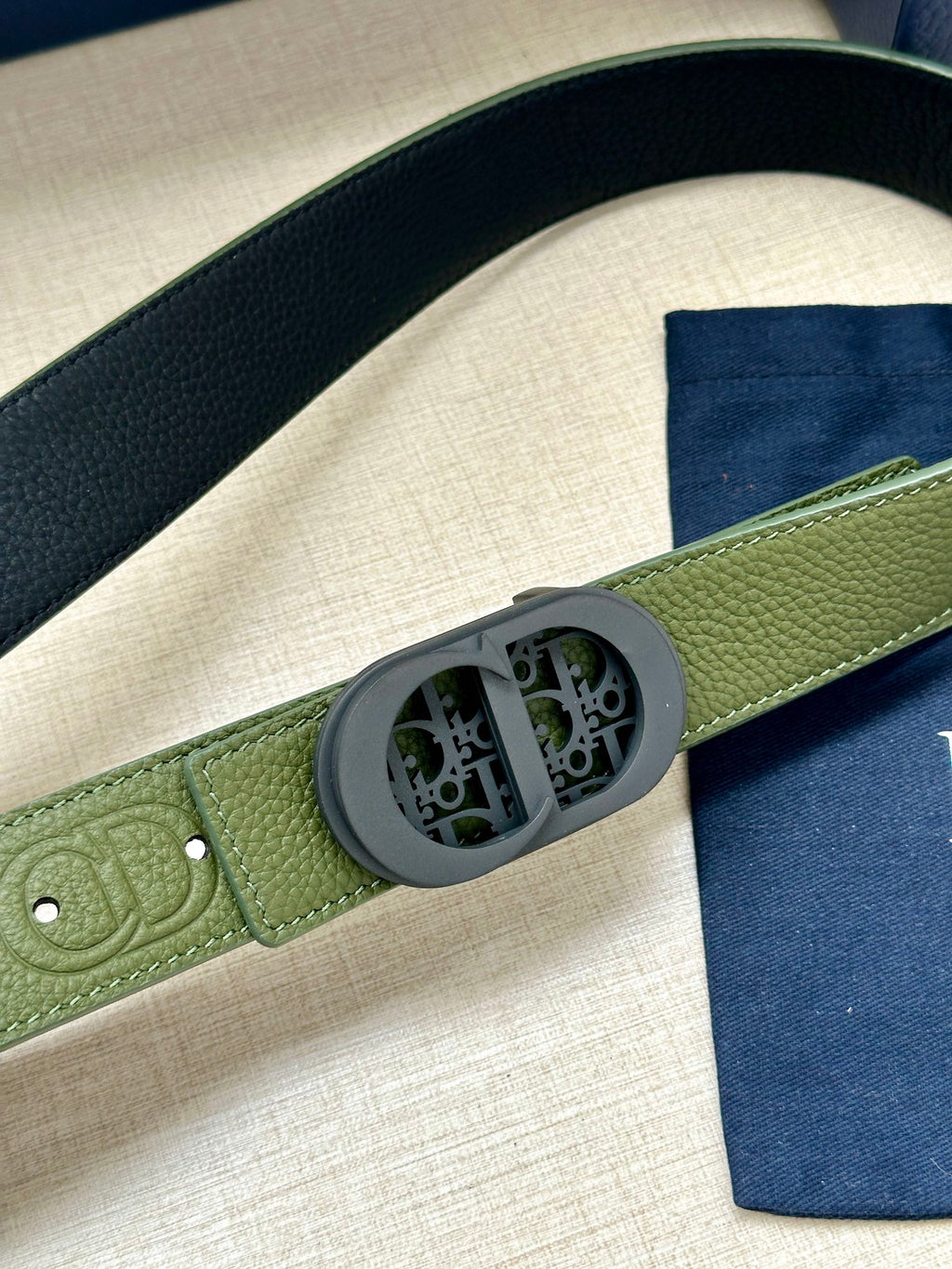 Green grained leather Dior belt with oval logo buckle close-up