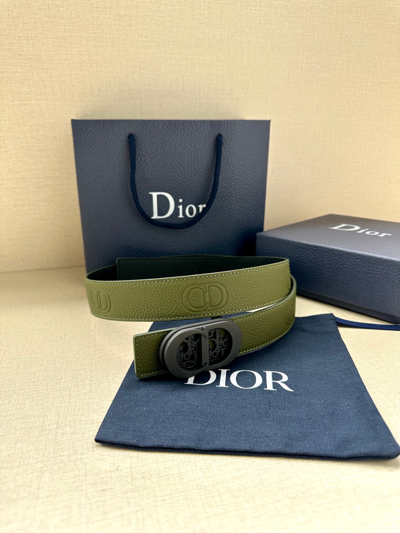 Green leather Dior belt with oval logo buckle and dark edge lining