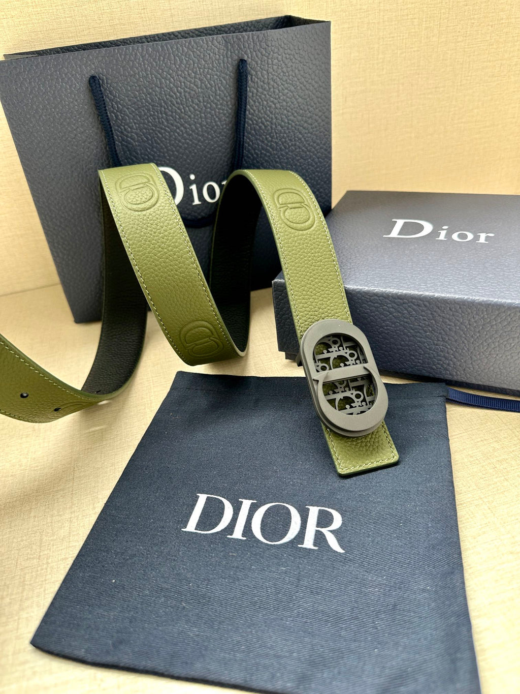 Green leather Dior belt with oval logo buckle and adjustable end tabs