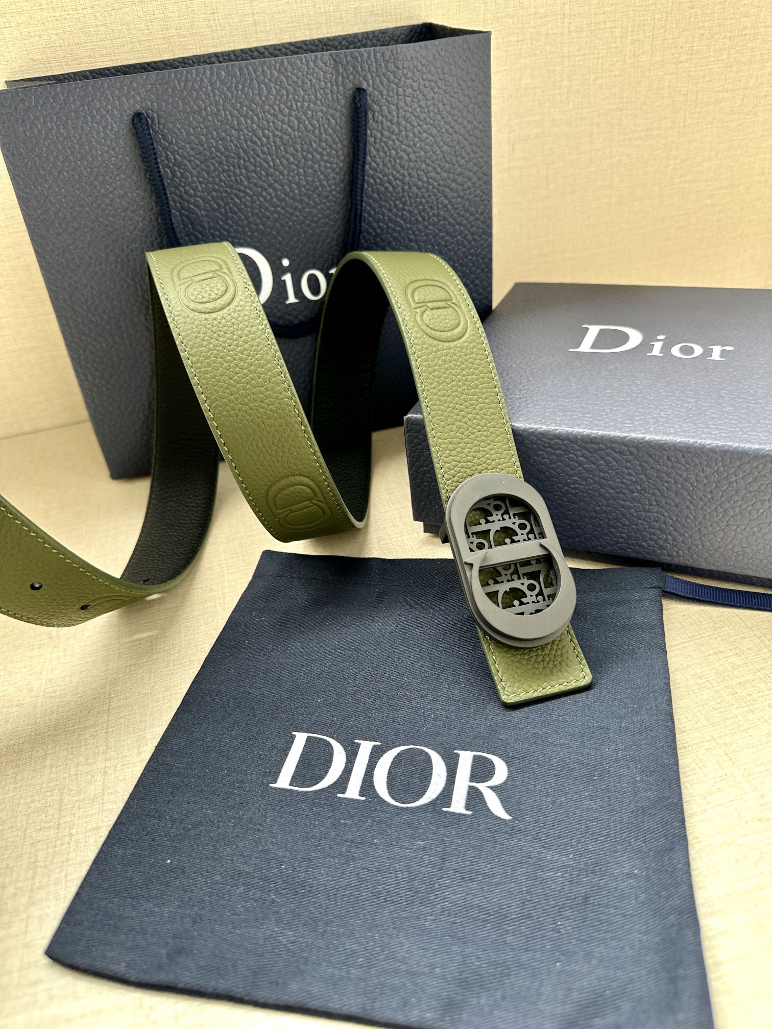 Green leather Dior belt with oval logo buckle and adjustable end tabs