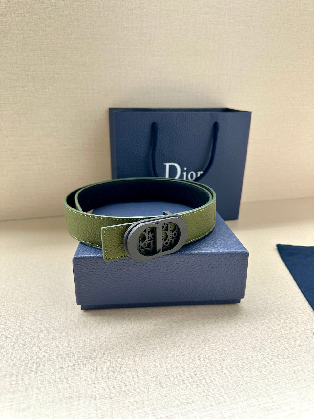 Green leather Dior belt with oval logo buckle, prong and punched holes