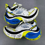 Silver and blue chunky sneakers with neon yellow trim, laces and padded sole
