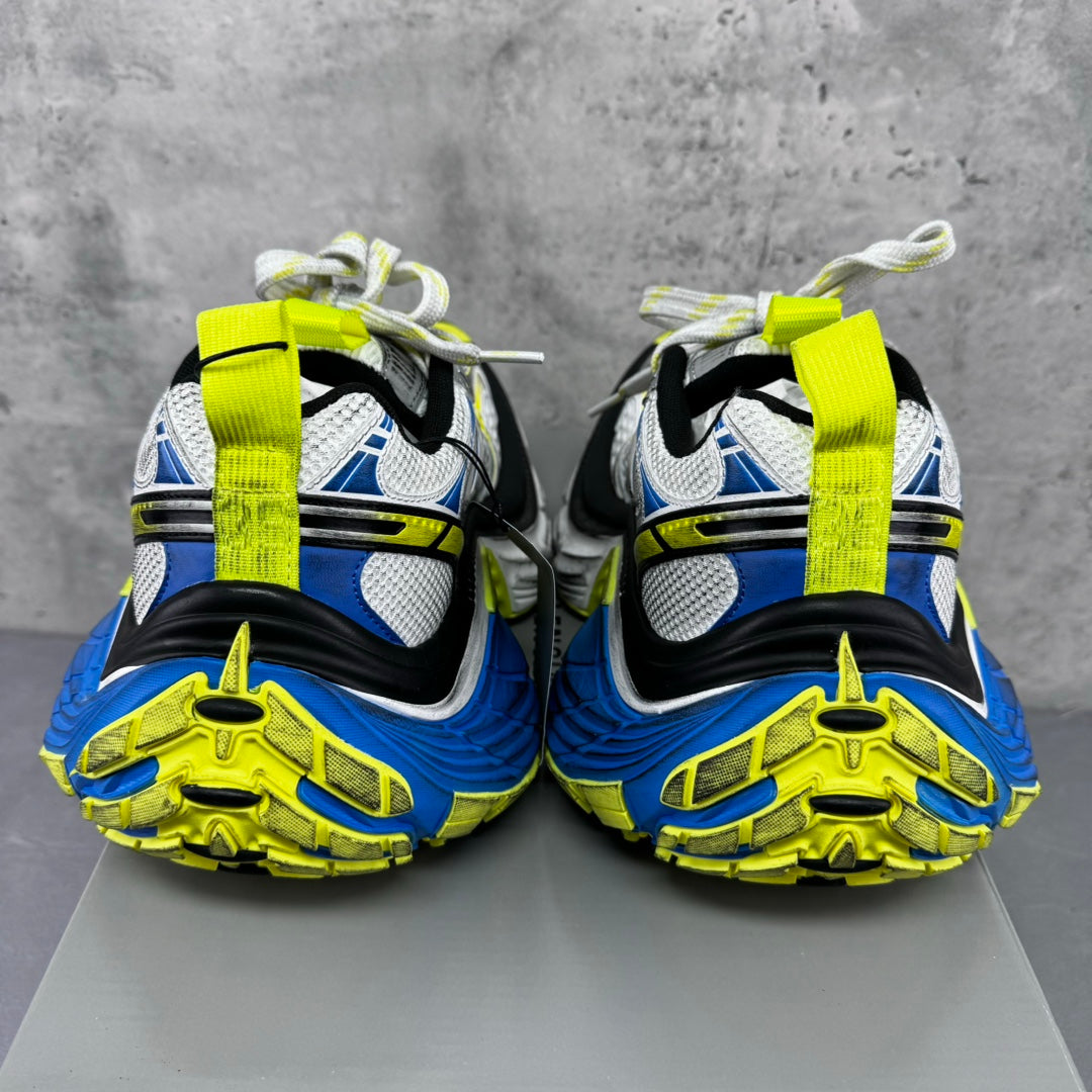 Back view of silver sneakers with blue and neon yellow accents, lace-up