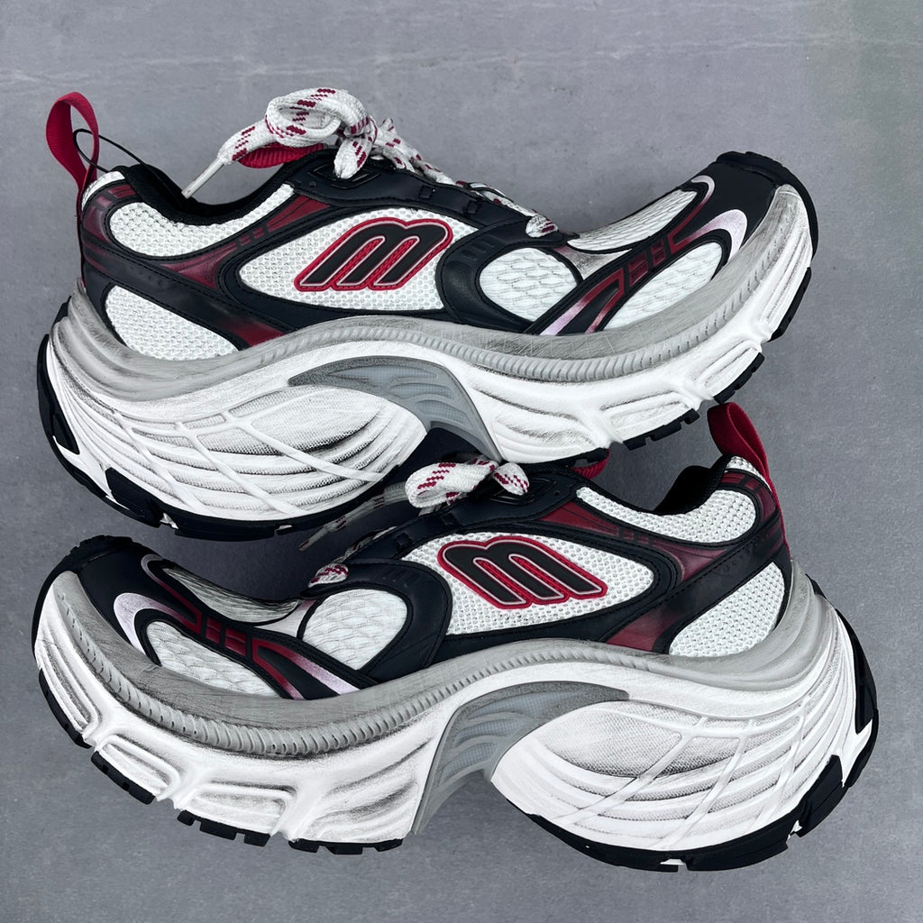 Balenciaga unisex chunky sneakers angled side view, black, white, and red logo