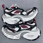Balenciaga unisex chunky sneakers angled side view, black, white, and red logo