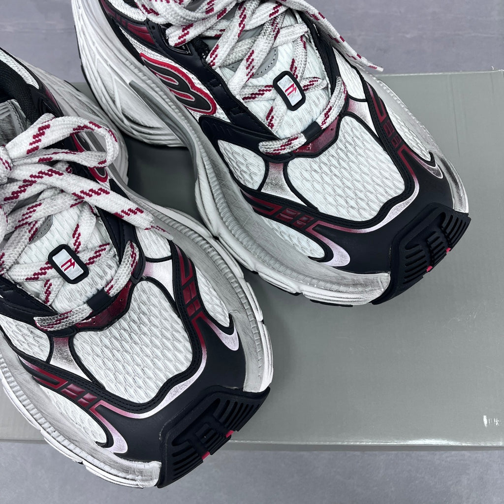 Balenciaga unisex sneaker upper close-up, white mesh with black trim and red details