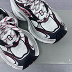 Balenciaga unisex sneaker upper close-up, white mesh with black trim and red details