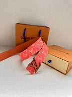 Louis Vuitton belt with pink monogram strap and LV buckle, angled view