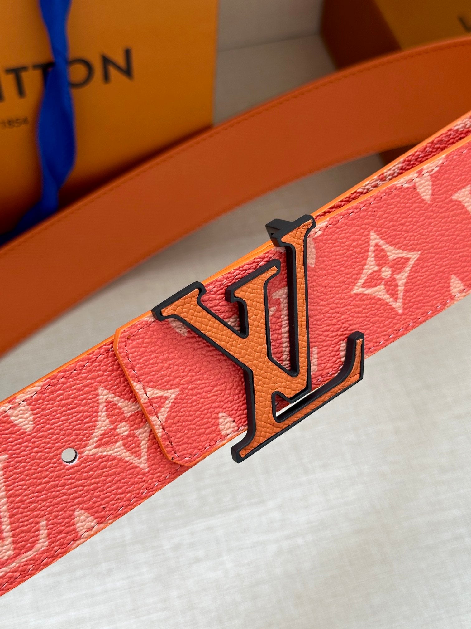 Louis Vuitton belt buckle on red monogram strap, metal LV clasp