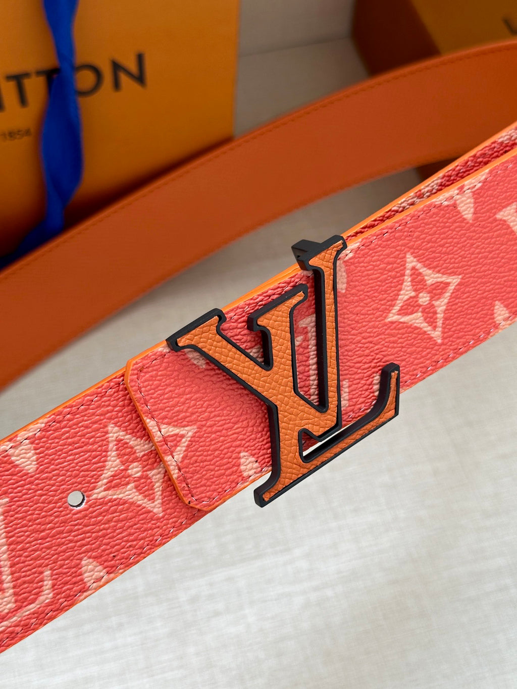 Louis Vuitton belt detail: pink monogram strap with large LV buckle
