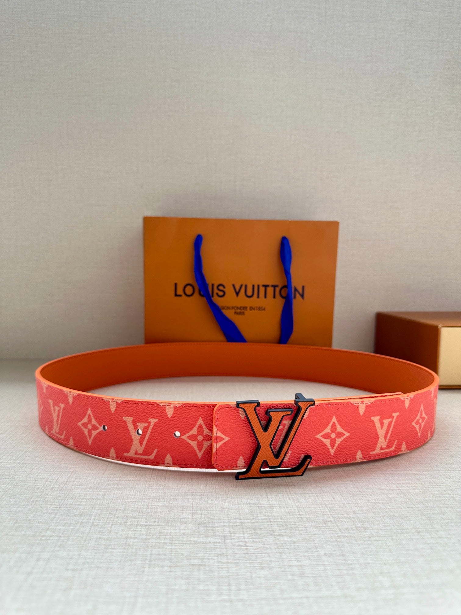 Louis Vuitton belt with red monogram strap and large metal LV buckle
