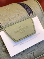 Louis Vuitton Paris label on light leather zip pouch with embossed monogram pattern