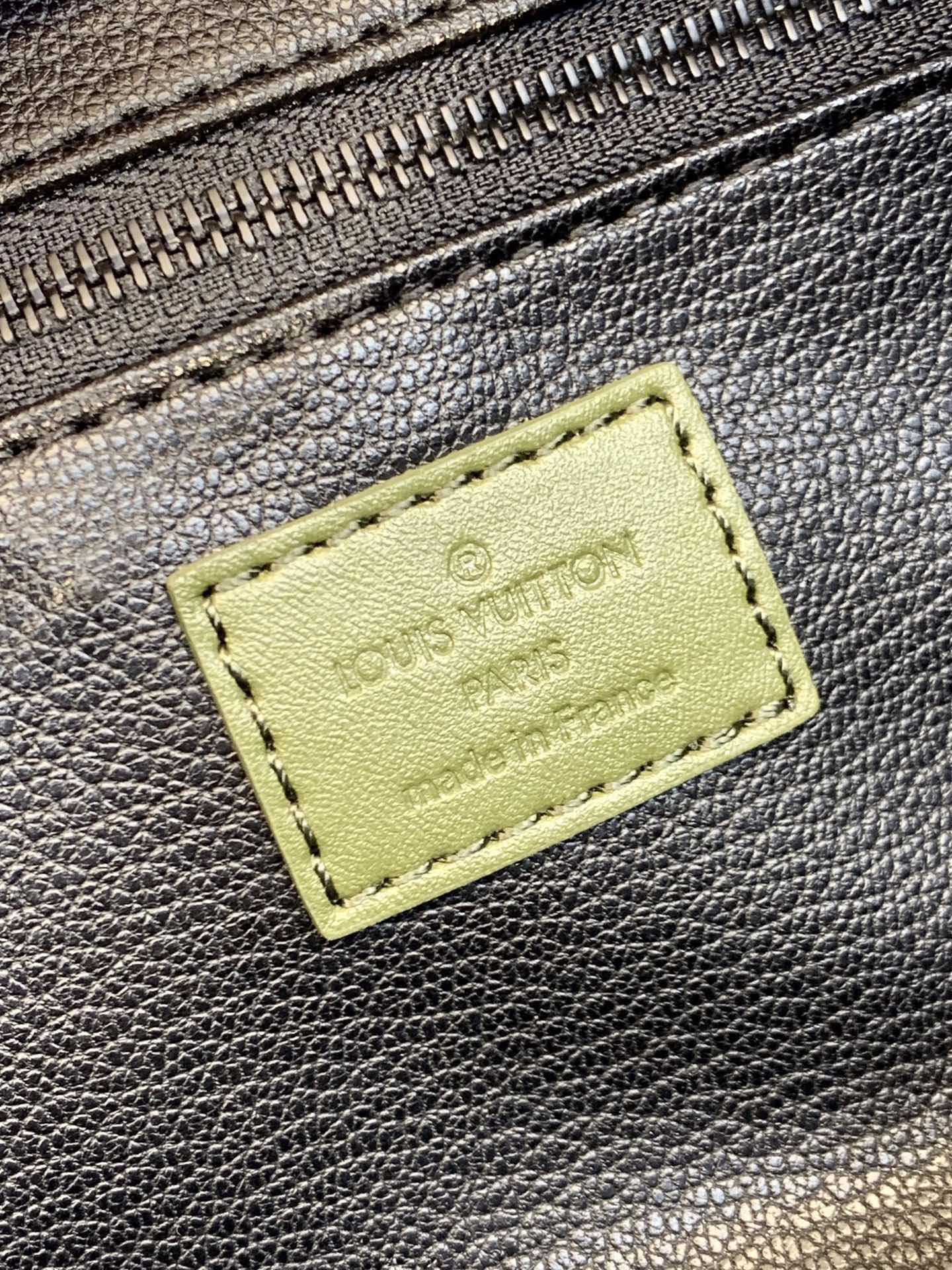 Louis Vuitton rectangular label on textured leather zip pouch in dark gray
