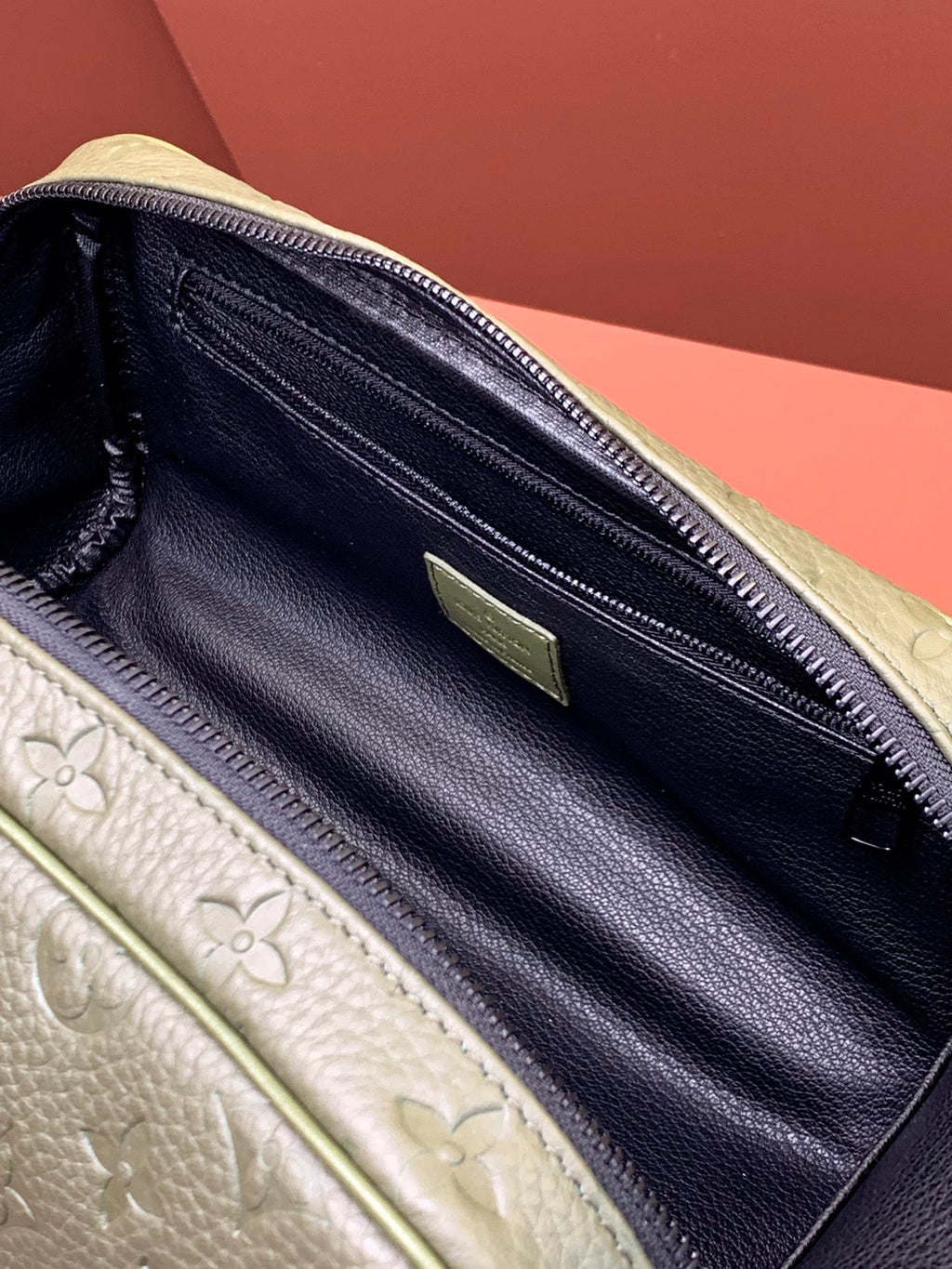 Louis Vuitton zip pouch interior with dark lining, zipper track, and green tab