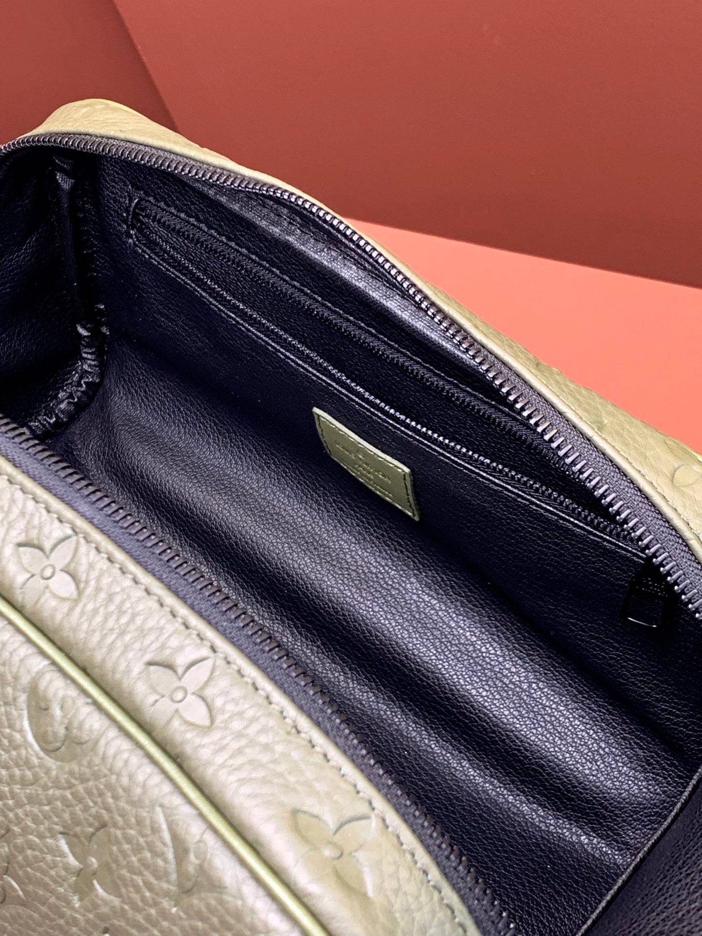 Louis Vuitton zip pouch interior with dark lining, zipper track, and green tab