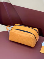 Mustard-yellow monogram crossbody bag with navy-trim top zip