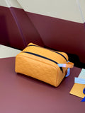 Mustard-yellow monogram crossbody bag with navy zip and strap
