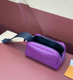 Purple embossed crossbody bag with open top and dark interior zipper trim