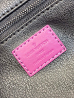 Pink leather label patch on dark textured bag material with metal zipper teeth
