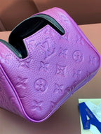 Purple embossed mini bag with pattern detailing, open top, and black inner pocket