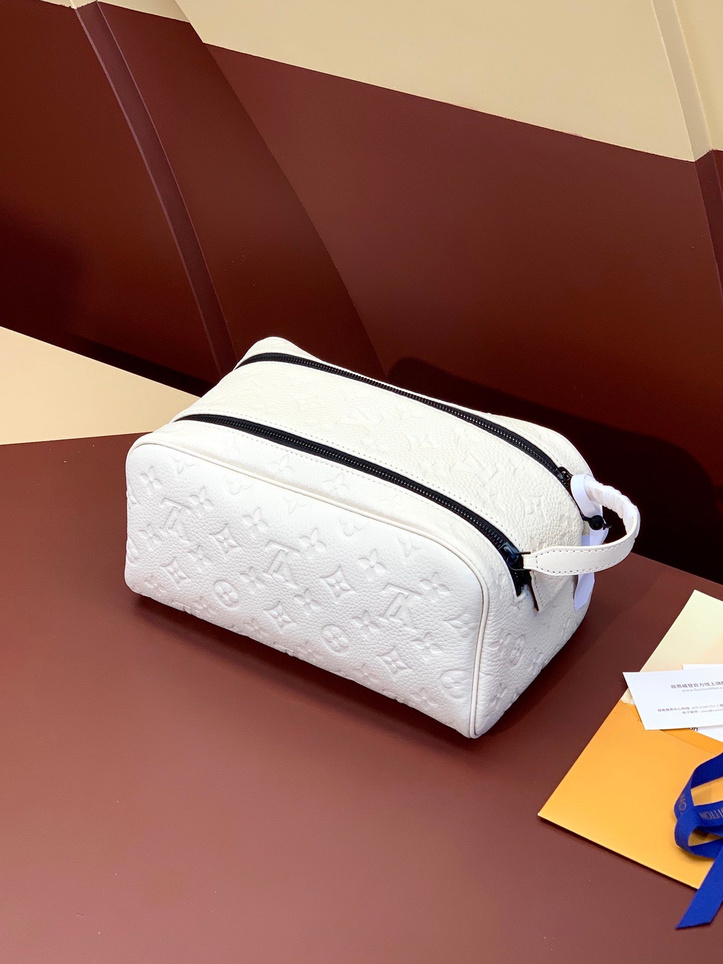Louis Vuitton pouch bag with white monogram leather and navy zip trim