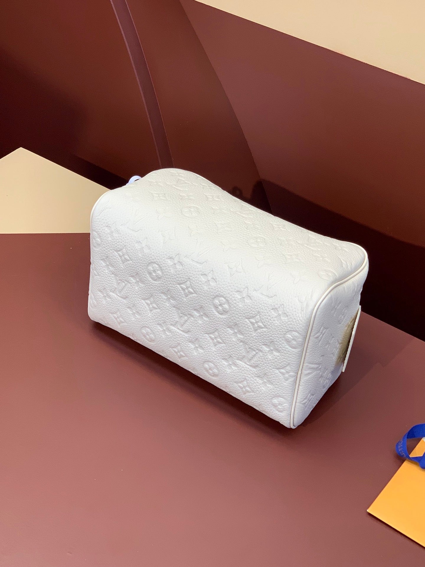 Louis Vuitton pouch bag in white embossed monogram with rounded top and zipper