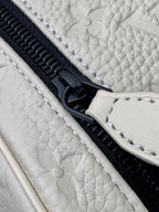Louis Vuitton zipper close-up on white monogram pouch with black hardware