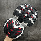 Balenciaga outsole view: black tread with red accents and white cushioning edges