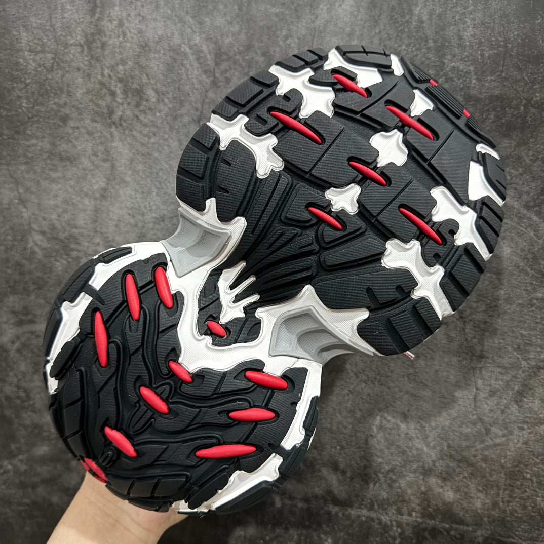 Balenciaga outsole view: black tread with red accents and white cushioning edges