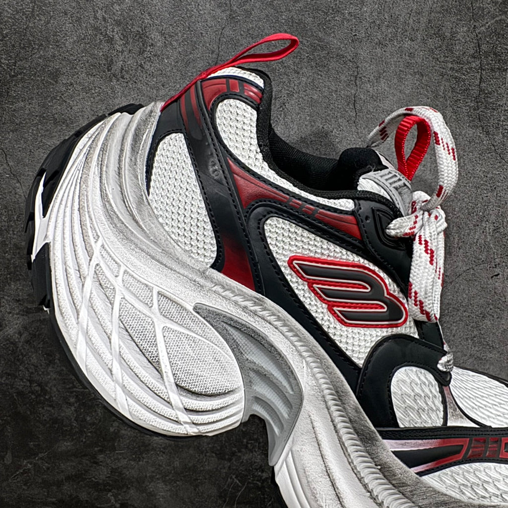 Balenciaga chunky sneakers, lateral view: black and white with red logo accents