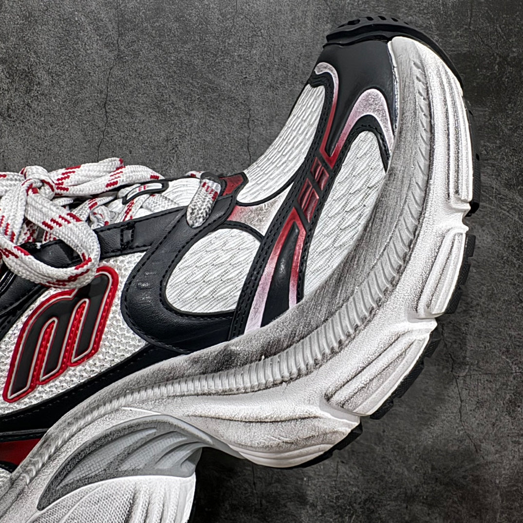 Balenciaga chunky sneakers, side detail: black upper, red stripes, white sole