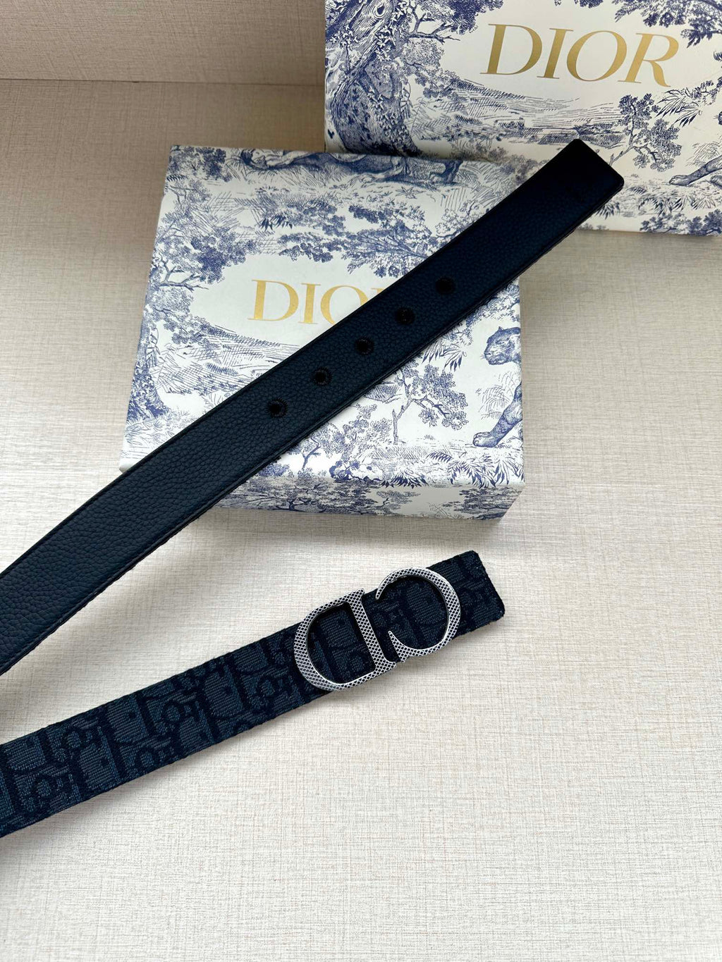 Dior belt strap with dark navy leather, visible eyelets and silver-tone CD buckle.
