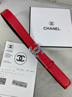 Chanel belt long red strap with blue-gold logo buckle, laid on Chanel boxes