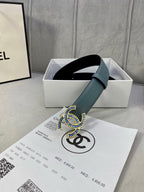Chanel belt in light blue with CC buckle resting in a gift box