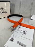 Belt: orange leather strap with blue-and-white CC logo buckle and punched holes.