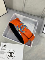 Belt in box: orange leather with blue-and-white CC logo buckle and black lining.