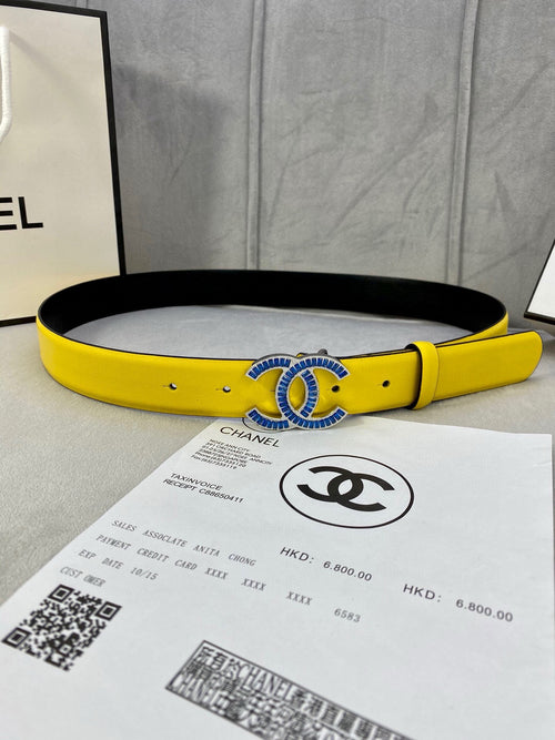 Chanel belt in bright yellow with blue CC-style buckle, black inner lining