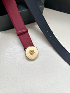 Red leather belt with round gold-tone Medusa buckle and perforation holes