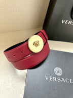 Red leather belt with round gold-tone Medusa buckle and stitched belt loops