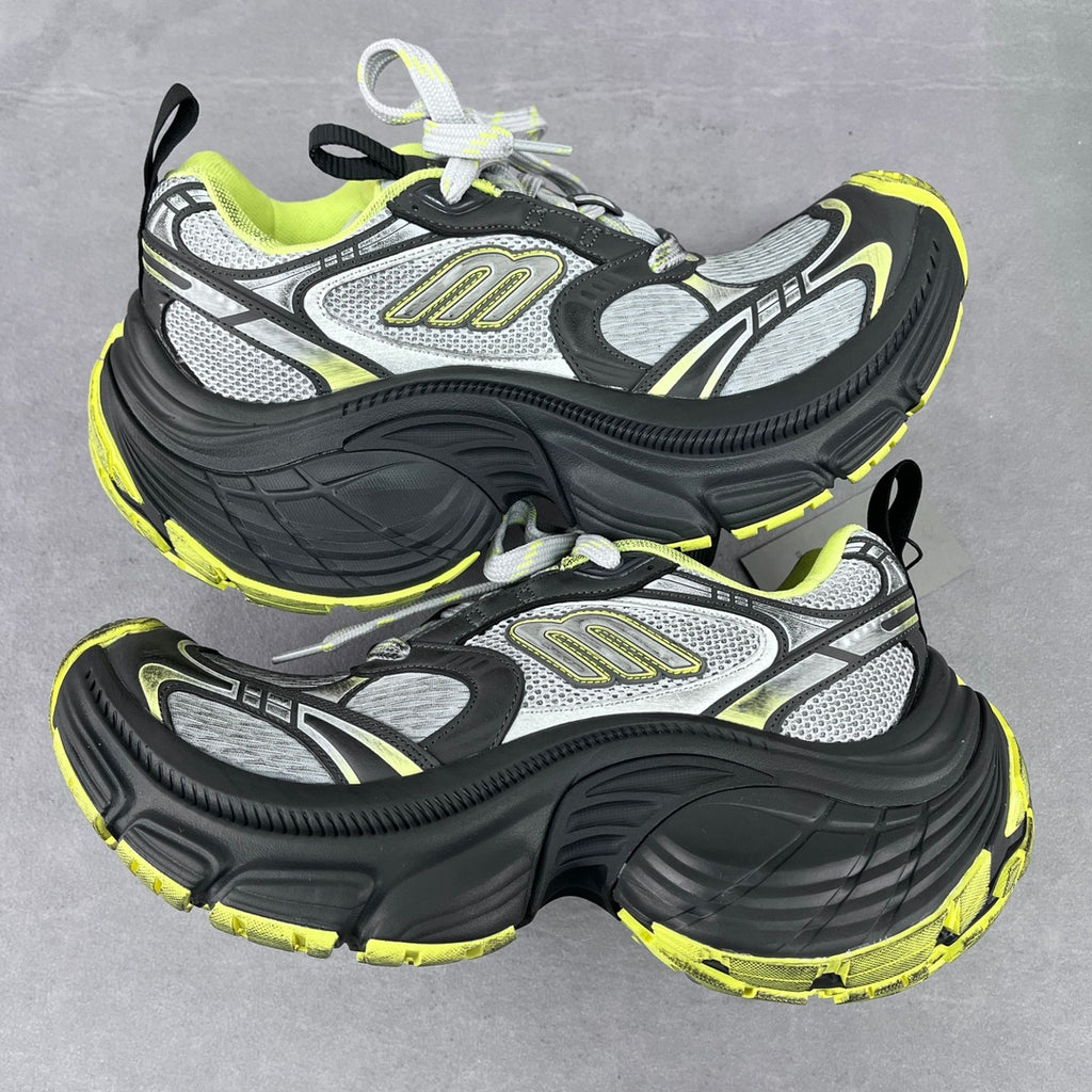 Chunky lace-up runner sneakers in gray, black, and neon yellow with logo panels