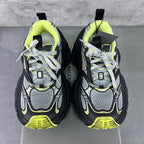 Two chunky sneakers facing forward with neon lime ankle lining and lace-up front