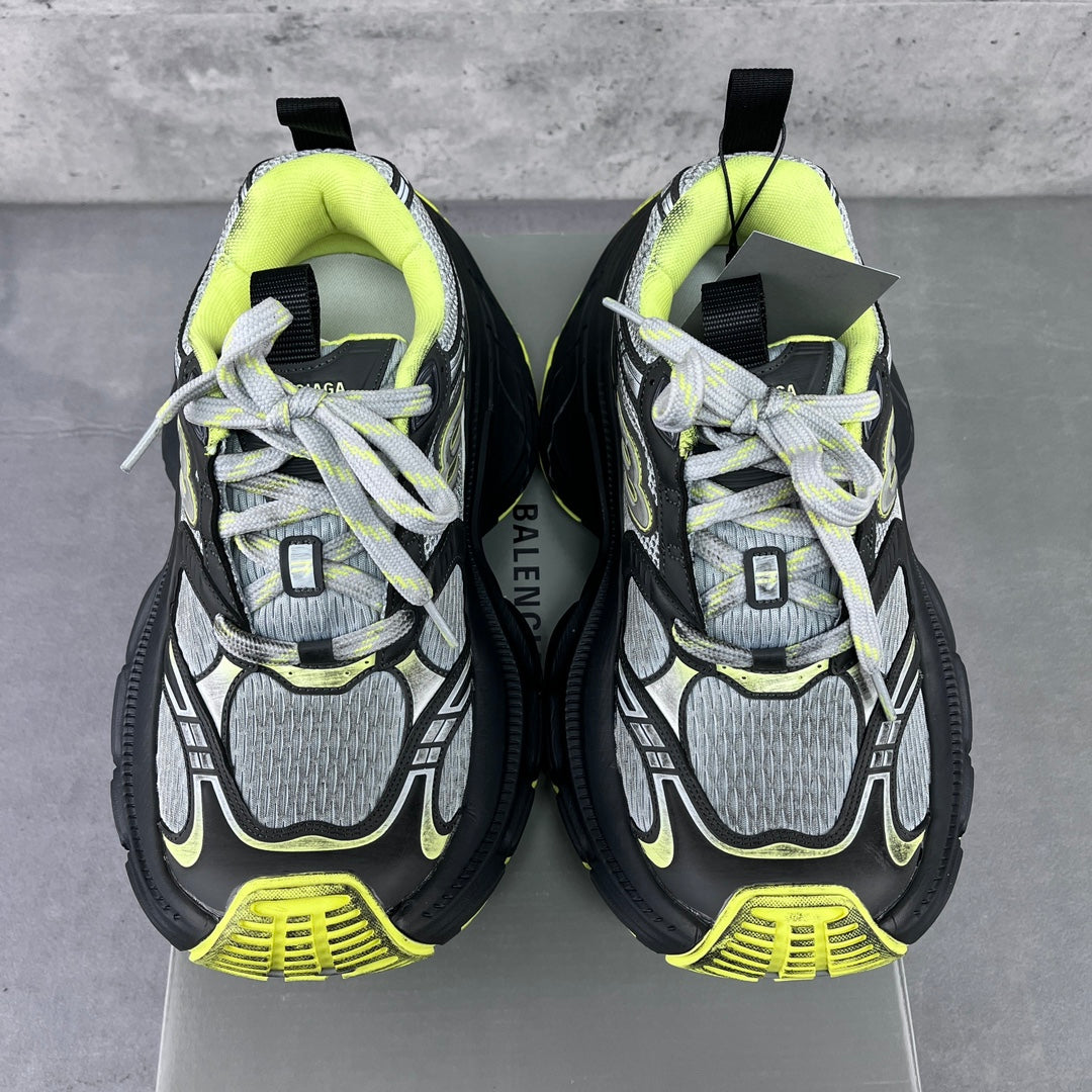 Two chunky sneakers facing forward with neon lime ankle lining and lace-up front