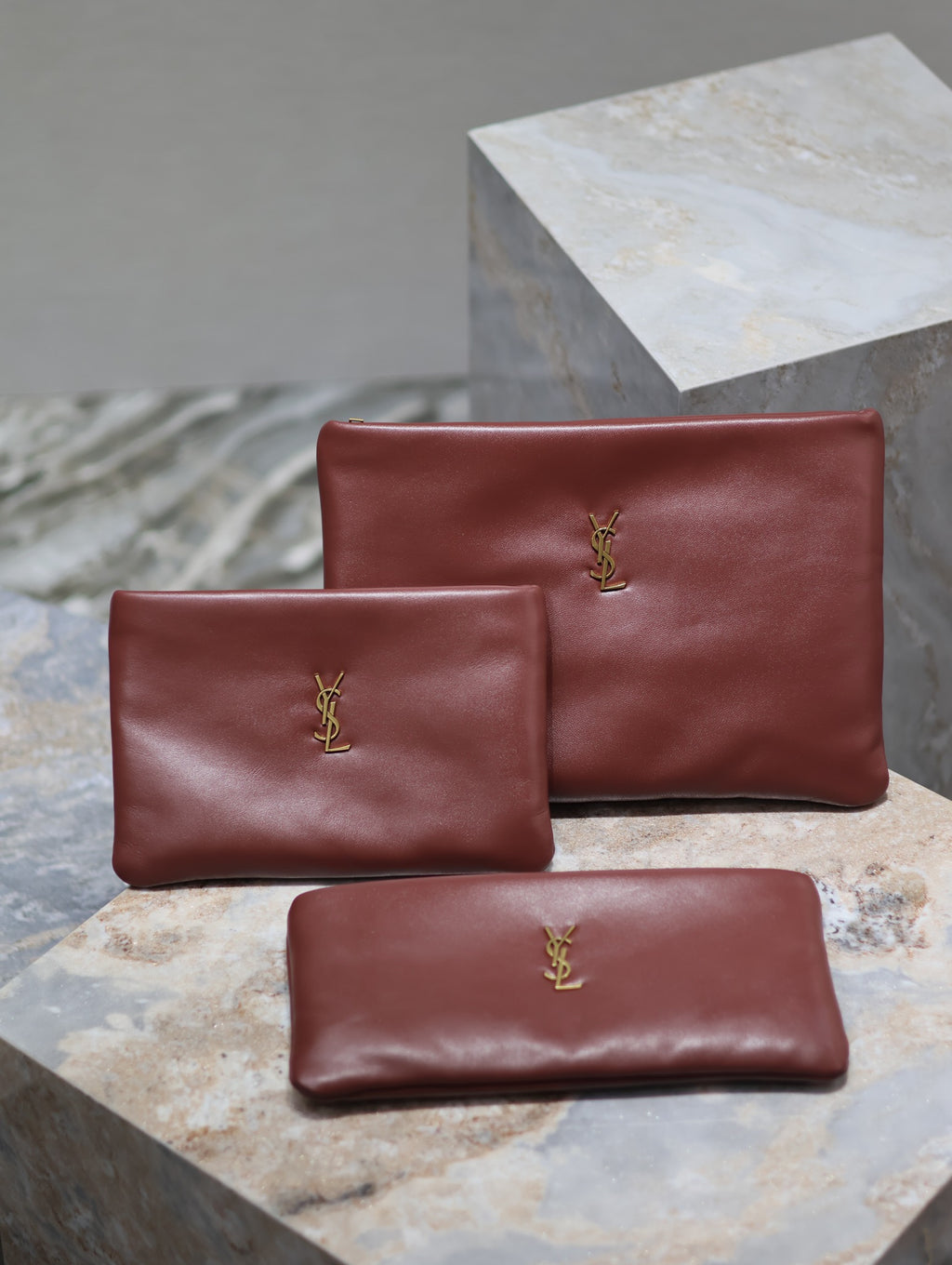 Burgundy leather small bag with gold YSL logo, plus matching compact pouch