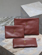 Burgundy leather small bag with gold YSL logo, plus matching compact pouch