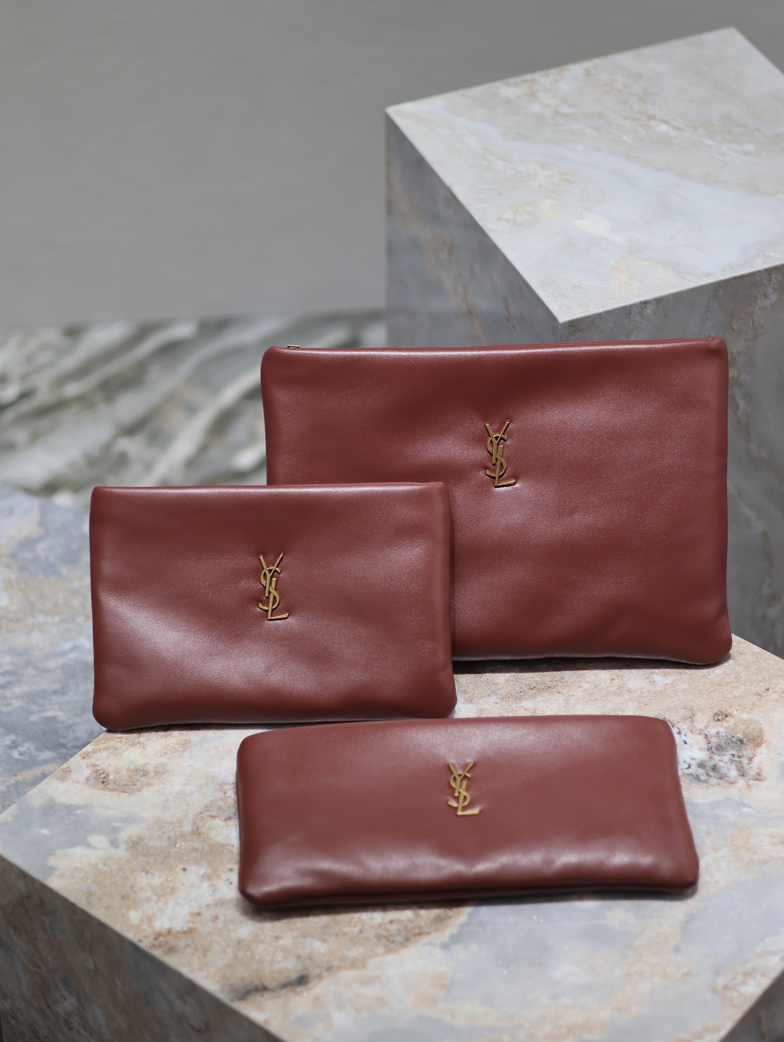 Burgundy leather small bag with gold YSL logo, plus matching compact pouch