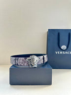 Floral leather belt with silver Medusa buckle on dark plum strap