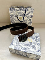 Dior belt with brown leather strap and oversized circular dark logo buckle