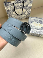 Dior belt close-up: light blue leather with dark CD buckle and stamped logo